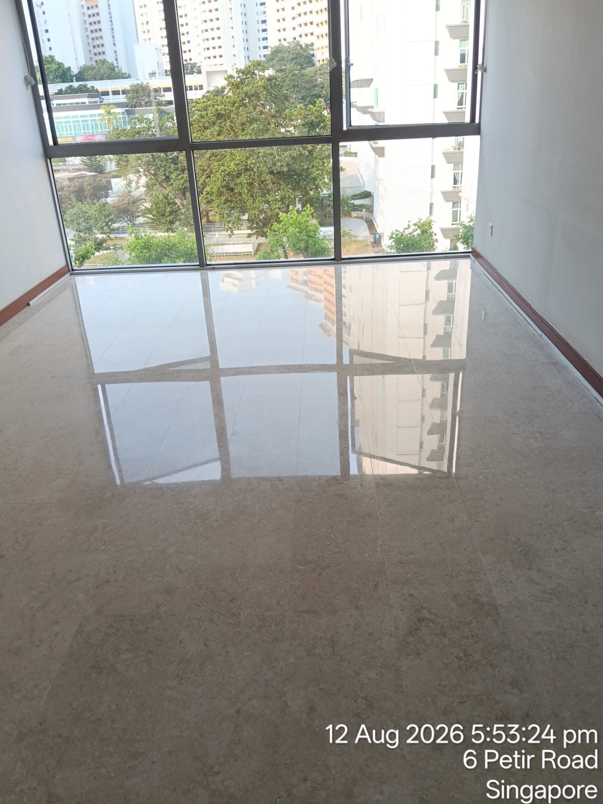 Polished marble floor in a Singapore condo unit reflecting the window view